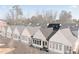 Row of charming white townhouses with gray roofs and skylights at 308 Chardonnay Way, Woodstock, GA 30188