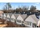 Aerial view of row of white townhouses with gray roofs and landscaping at 308 Chardonnay Way, Woodstock, GA 30188