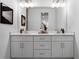 Double vanity bathroom with white cabinets and quartz countertops at 308 Chardonnay Way, Woodstock, GA 30188