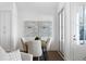 Elegant dining area with a wood table and comfortable seating near French doors at 308 Chardonnay Way, Woodstock, GA 30188