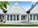 Exterior of a charming white townhouse with a front porch, and well-maintained lawn at 308 Chardonnay Way, Woodstock, GA 30188