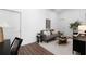 Open living room with a gray sofa and dark wood coffee table at 308 Chardonnay Way, Woodstock, GA 30188