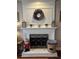 White brick fireplace with decorative wreath and screen at 1025 Charleston Trce, Roswell, GA 30075