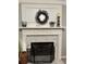 Fireplace with white mantel and marble surround at 1025 Charleston Trce, Roswell, GA 30075