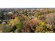 An autumn aerial view of a home nestled within a canopy of colorful fall foliage at 413 Cranfill Se Rd, Marietta, GA 30060