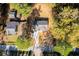 Overhead aerial shot of the home, featuring mature trees, a driveway and neighboring houses at 413 Cranfill Se Rd, Marietta, GA 30060