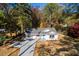 Aerial view of a charming home with a long driveway, a large front yard, and mature trees at 413 Cranfill Se Rd, Marietta, GA 30060