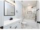 Bathroom featuring a vanity and tub with white marble style tile at 413 Cranfill Se Rd, Marietta, GA 30060