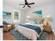 Serene bedroom with coastal decor, a ceiling fan, and a wicker chair with blue accents at 413 Cranfill Se Rd, Marietta, GA 30060