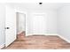 Bedroom includes hardwood floors, white trim, and a double-door closet at 413 Cranfill Se Rd, Marietta, GA 30060