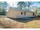 Rear exterior showing the freshly painted siding and stone-lined foundation at 413 Cranfill Se Rd, Marietta, GA 30060