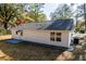 Rear view of the property with white siding, a concrete patio, AC unit and manicured gravel at 413 Cranfill Se Rd, Marietta, GA 30060