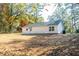 Beautiful backyard view showcasing the home's exterior, spacious lawn, and mature trees at 413 Cranfill Se Rd, Marietta, GA 30060