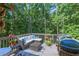 Comfortable back deck area with a grill and outdoor seating area, surrounded by lush greenery at 27 Danbury Hill # Coweta, Sharpsburg, GA 30277