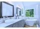 Modern bathroom with dual vanities, a soaking tub, and natural light at 27 Danbury Hill # Coweta, Sharpsburg, GA 30277