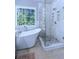 Elegant bathroom featuring a glass-enclosed shower and a luxurious soaking tub at 27 Danbury Hill # Coweta, Sharpsburg, GA 30277