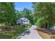 Traditional home with a long driveway surrounded by lush trees at 27 Danbury Hill # Coweta, Sharpsburg, GA 30277