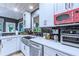 Well-equipped kitchen with stainless steel appliances, white cabinets, and contrasting dark backsplash at 27 Danbury Hill # Coweta, Sharpsburg, GA 30277