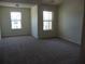 Spacious bedroom with carpeted flooring and two windows at 52 Providence Oak Ct, Lawrenceville, GA 30046