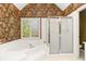 Bathroom featuring a tub, shower with glass door and patterned wallpaper at 4311 Clairesbrook Ln, Acworth, GA 30101