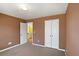 Bedroom with carpet, closet, brown walls, and view of a yellow bathroom at 4311 Clairesbrook Ln, Acworth, GA 30101