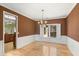 Dining room featuring hardwood floors, white wainscoting, and a chandelier at 4311 Clairesbrook Ln, Acworth, GA 30101