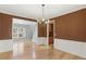 Dining room featuring hardwood floors, white wainscoting, and a chandelier at 4311 Clairesbrook Ln, Acworth, GA 30101