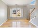 Bright living room with hardwood floors, large windows with shutters, and stairs in view at 4311 Clairesbrook Ln, Acworth, GA 30101