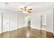 Spacious bedroom featuring hardwood floors, a ceiling fan, and access to the bathroom at 6323 Wedgeview Dr, Tucker, GA 30084