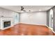 Bright living room featuring a ceiling fan, modern light fixture, and a fireplace at 6323 Wedgeview Dr, Tucker, GA 30084