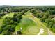 Beautiful aerial view of lush golf course, pond and mature trees in community at 6705 Brookline Ct, Cumming, GA 30040