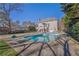 A backyard view of a house with a swimming pool and spacious lawn at 6705 Brookline Ct, Cumming, GA 30040