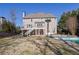 View of a two-story home with a large back deck overlooking a swimming pool and backyard at 6705 Brookline Ct, Cumming, GA 30040