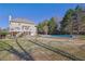 Expansive backyard featuring an in-ground pool, deck, and lush greenery at 6705 Brookline Ct, Cumming, GA 30040