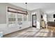 Dining area with large windows, wood floors, and a view of the backyard at 6705 Brookline Ct, Cumming, GA 30040