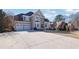 Stately two-story home with a manicured lawn, three-car garage, and a beautiful stone and stucco facade at 6705 Brookline Ct, Cumming, GA 30040