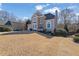 Traditional home featuring a manicured front yard, arched windows, and a two-car garage at 6705 Brookline Ct, Cumming, GA 30040