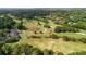 Aerial of golf course with mature trees, scenic water feature and clubhouse at 6705 Brookline Ct, Cumming, GA 30040