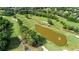 Aerial shot of a well-maintained golf course with mature trees and ponds for scenic views at 6705 Brookline Ct, Cumming, GA 30040