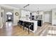 Well-lit kitchen with white cabinets, stainless steel appliances, and a breakfast bar with black stools at 6705 Brookline Ct, Cumming, GA 30040