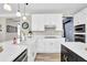 Contemporary kitchen with white countertops, shaker cabinets, and stainless steel appliances at 6705 Brookline Ct, Cumming, GA 30040