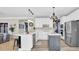 Bright kitchen featuring white cabinets, stainless steel appliances, and a contrasting gray island at 6705 Brookline Ct, Cumming, GA 30040