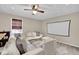 Finished basement living room with a large sofa, ceiling fan, and neutral carpet at 6705 Brookline Ct, Cumming, GA 30040