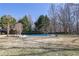 In-ground pool in the backyard with a grassy yard and mature trees at 6705 Brookline Ct, Cumming, GA 30040