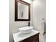 Stylish powder room with a vessel sink, wood accents, and a decorative mirror at 6705 Brookline Ct, Cumming, GA 30040