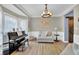 Comfortable sitting room featuring a piano, natural light, and wood floors at 6705 Brookline Ct, Cumming, GA 30040