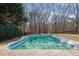 A classic backyard pool surrounded by a patterned stone deck and mature trees at 6705 Brookline Ct, Cumming, GA 30040