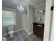 Bathroom with a shower, dual sinks, and patterned tile floor at 31 N Broad N St, Porterdale, GA 30014