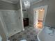 Bathroom featuring a soaking tub, separate shower, and patterned tile flooring at 31 N Broad N St, Porterdale, GA 30014