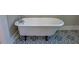 Charming bathroom with clawfoot tub and decorative tile flooring at 31 N Broad N St, Porterdale, GA 30014